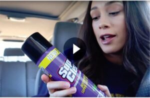 Still frame of video of Mrs. Farrington holding can of Super Clean Aerosol with play button