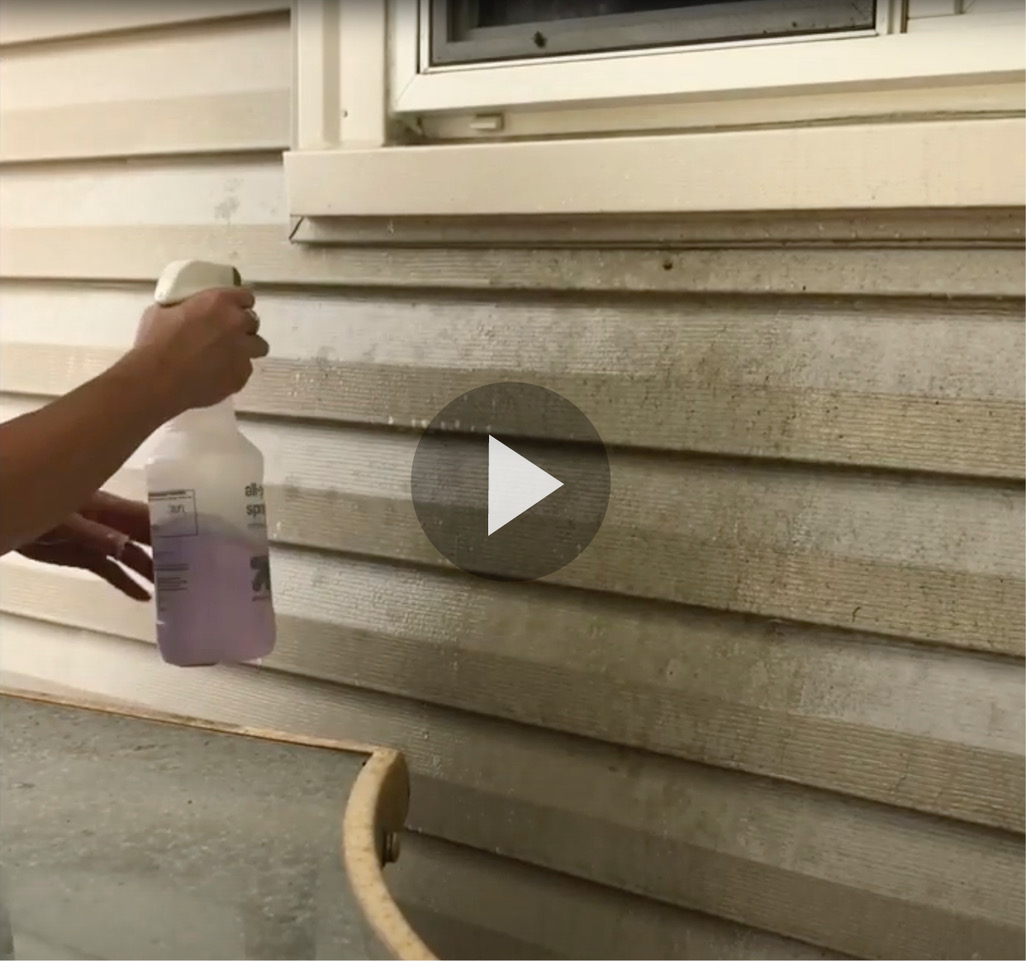 Still frame of video with spraying super clean on siding