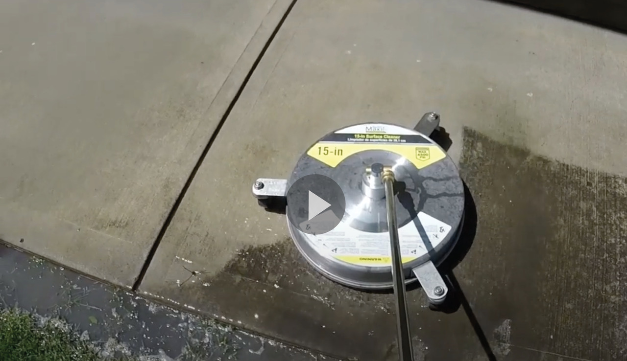 Still shot of video of pressure washer cleaning concrete