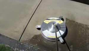 Pressure washer cleaning concrete