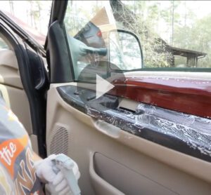 Video still of interior panel of car door being cleaned