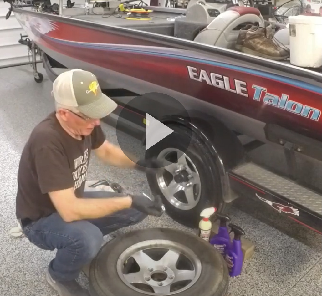 Still shot of video showing boat trailer tire being cleaned with Super Clean