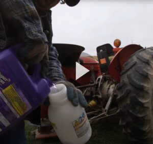 Still Frame of video cleaning a fertilizer spreader with Super Clean