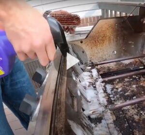 Still of video of man spraying grill with Super Clean