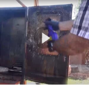 Still of video of man spraying smoker door with Super Clean